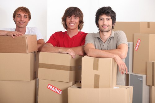 Staff member in PPE handling furniture during a van move