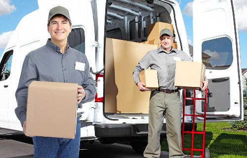 Staff coordinating a safe move while carrying items through a property